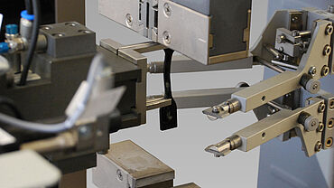 ASTM D412 - Test di trazione su elastomeri e gomma - dettaglio di un elastomero a manubrio, afferraggio ed estensimetro